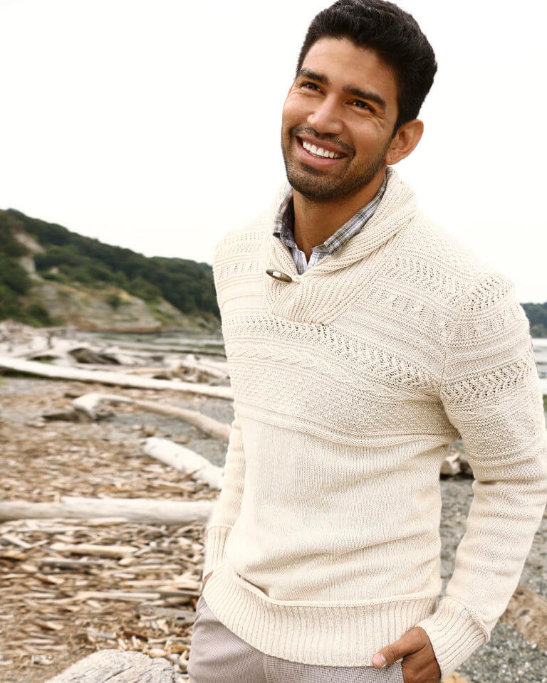 Christian Lopez on beach dressed in casual work clothes