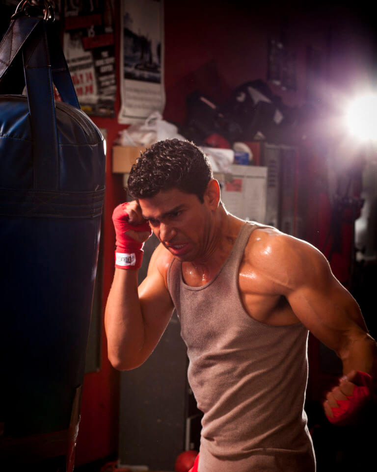 Christian Lopez boxing with heavy bag