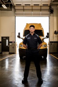 Christian Lopez Penske Standing in front of truck